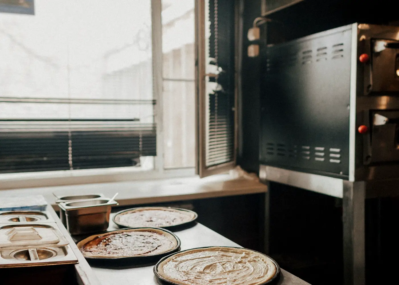 Pizza preparation area beside an oven