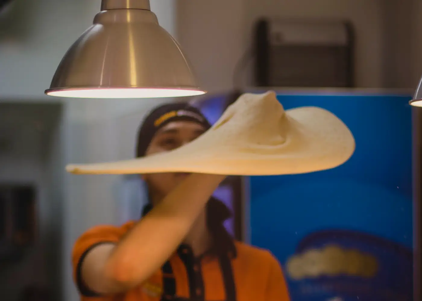 Pizza maker tossing dough